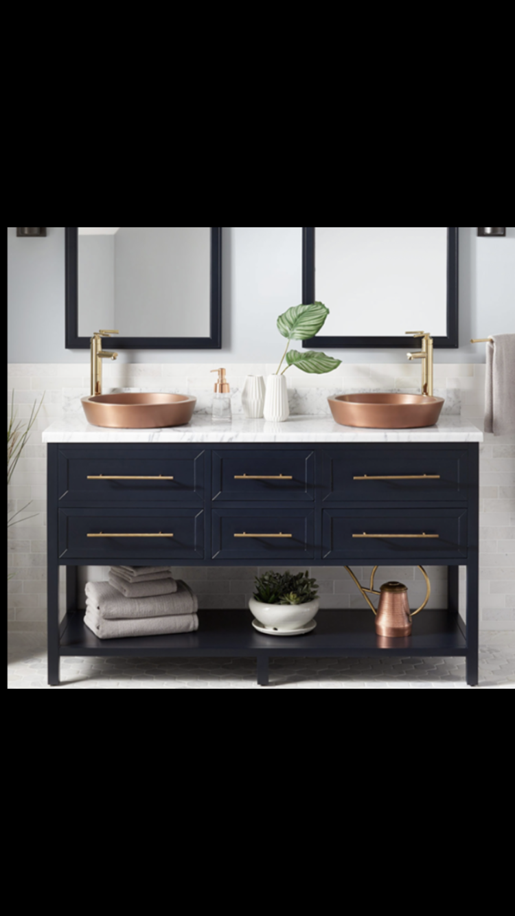Navy blue open-shelf vanity with marble top and copper vessel sinks