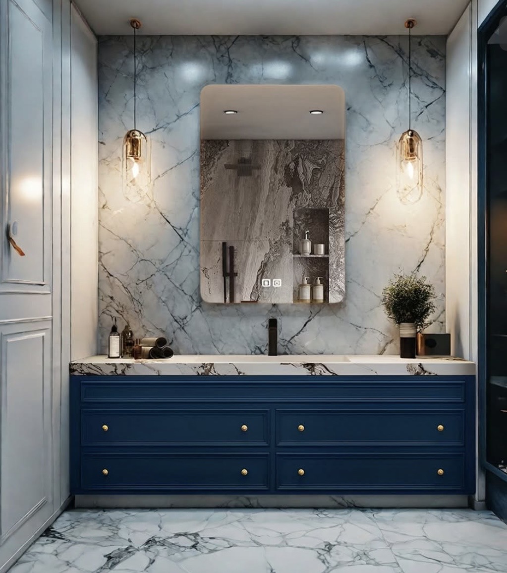 Blue fluted vanity with marble slab wall and pendant lighting
