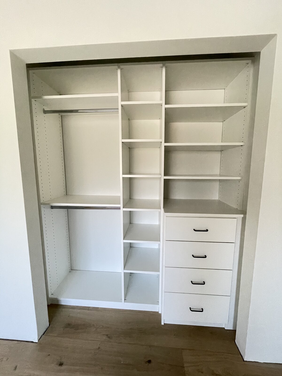 Walk-in closet with adjustable shelving and drawer bank